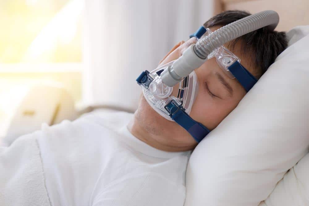 Sleeping with a CPAP mask on a pillow